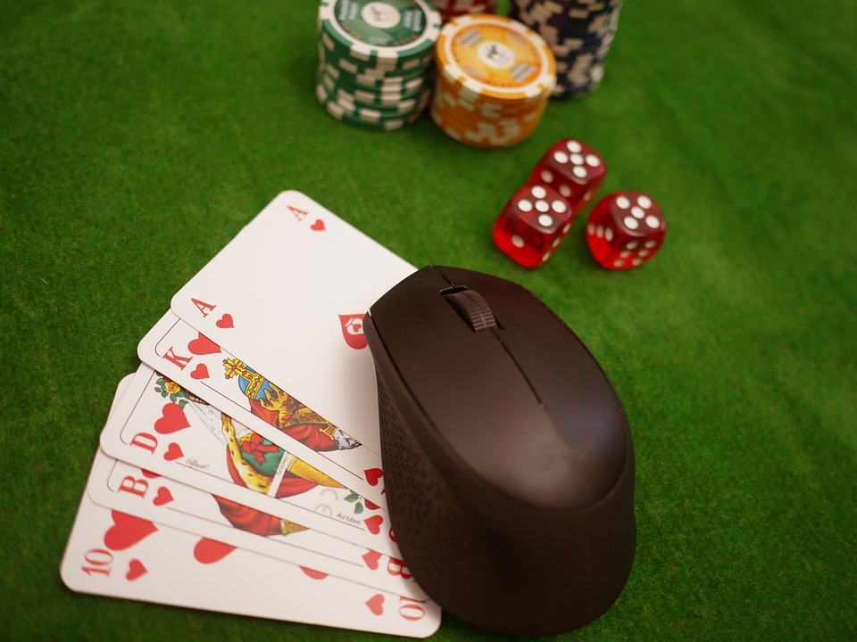 a computer mouse on top of poker cards