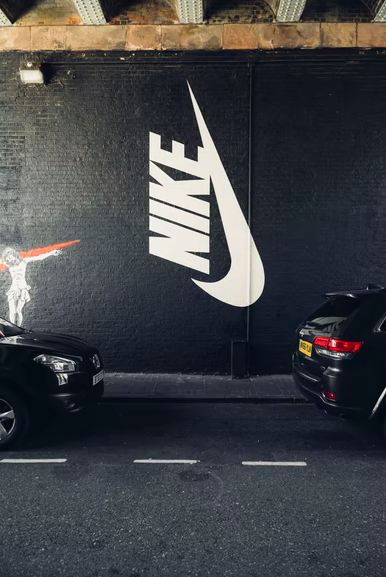 Parked-vehicles-beside-Nike-wall