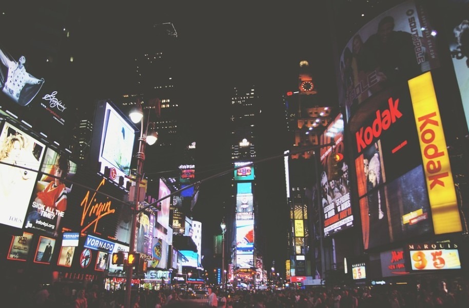 buildings-billboards-lights-and-people-in-a-street-in-New-York-at-night
